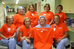 group photo of women in orange shrits